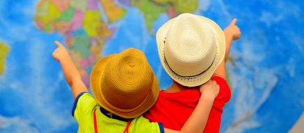 Two children pointing at a map