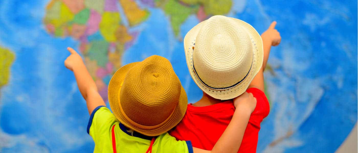 Two children pointing at a map