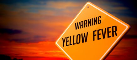 Yellow fever warning sign against sunset