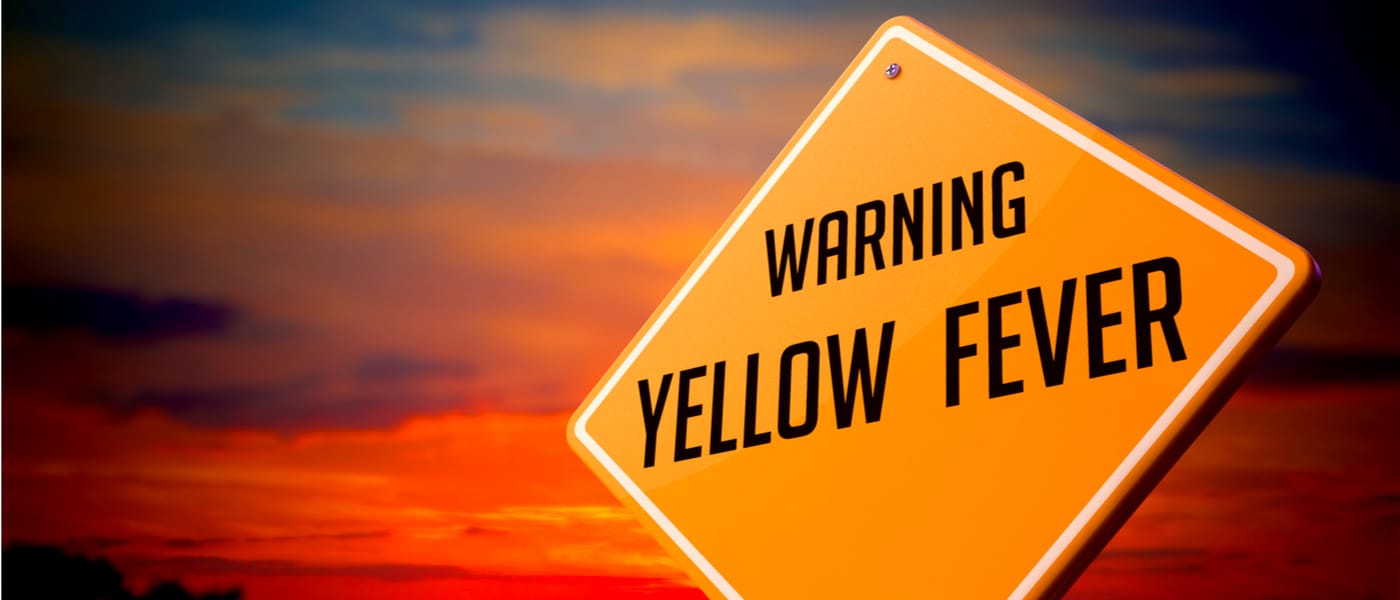 Yellow fever warning sign against sunset