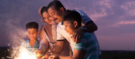 A family with sparklers celebrating Diwali the festival of light