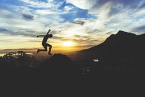 Man jumping off a rock