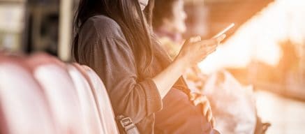 Pregnant woman sat down on her phone