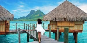 Lady looking towards the sea and Otemanu mountain at Bora Bora island, French Polynesia, Pacific ocean