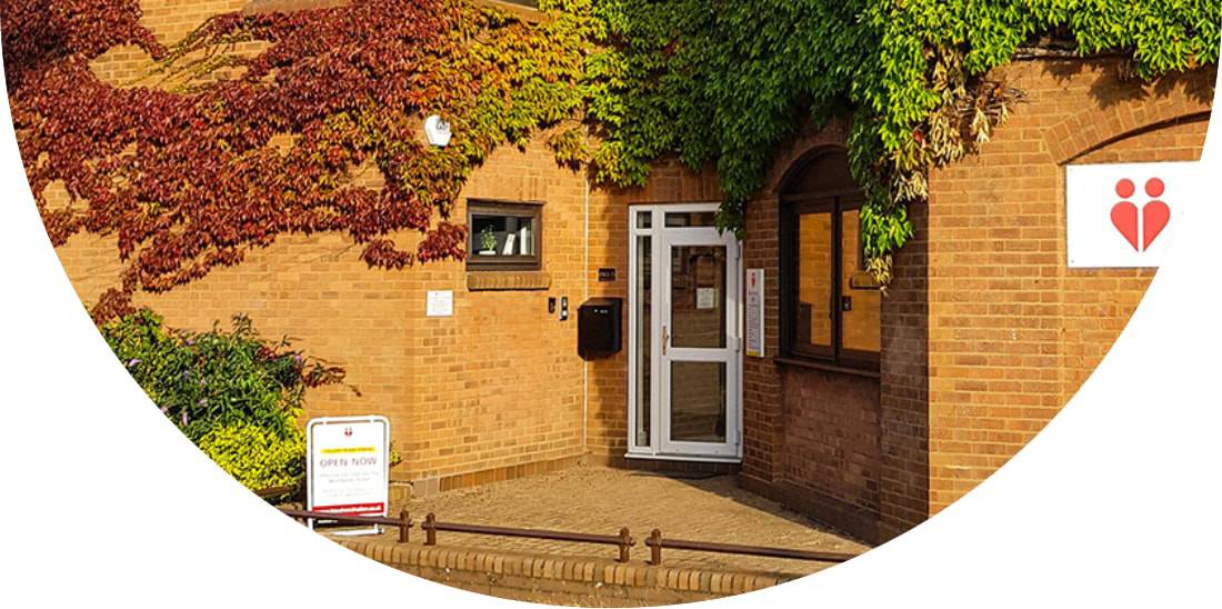 External of Hitchin travel vaccination clinic, a brick building with ivy on, centrally located in the town on Portmill Lane