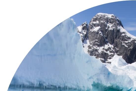 Iceberg and snowy mountain in Antarctica