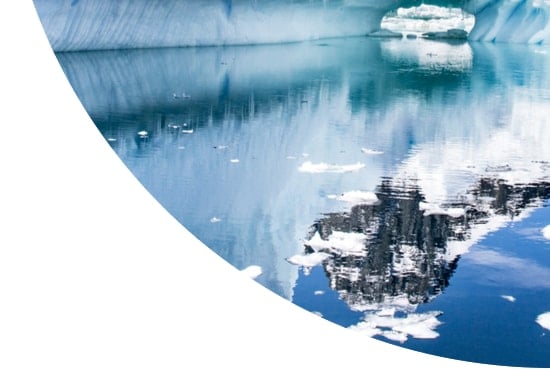 Reflection of iceberg and snowy mountain in Antarctica