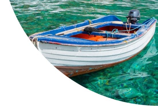 Stationary boat in blue sea in Greece