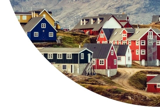 Colourful houses in front of mountains in Tasiilaq village, Greenland