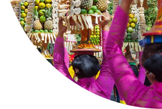 Women carrying fruit and flowers in Indonesia