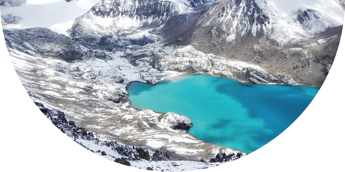 Smaragd water of misty Ala Kul lake in Terskey Alatoo mountains, Karakol national park, Kyrgyzstan