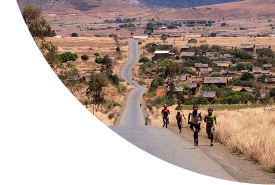 Children running on a road in Madagascar