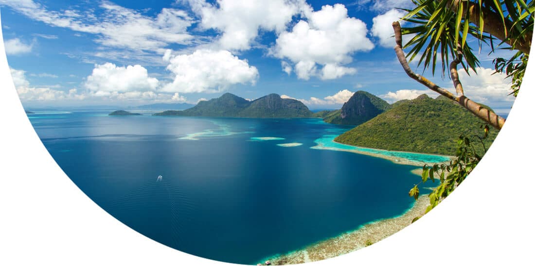 Blue water and tree covered hills in Malaysia