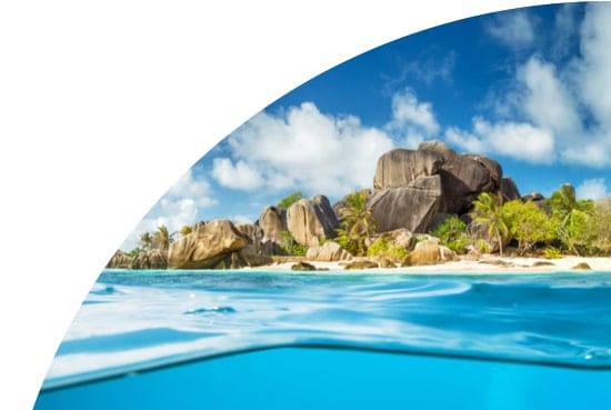 Rocks and palm trees on a beach in the Seychelles