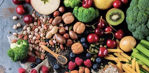 Fruit, vegtables, nuts and pasta on a table