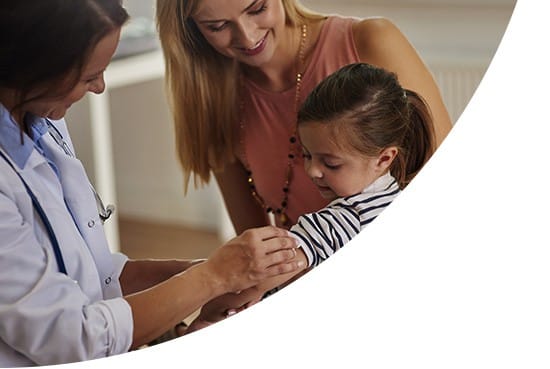 Nurse giving injection to a child with her mother