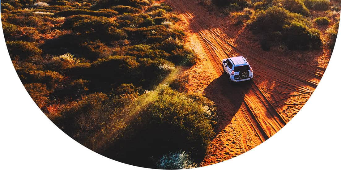 Car driving on a sandy road in Australasia