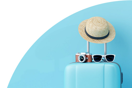 Hat, camera and sunglasses on a suitcase