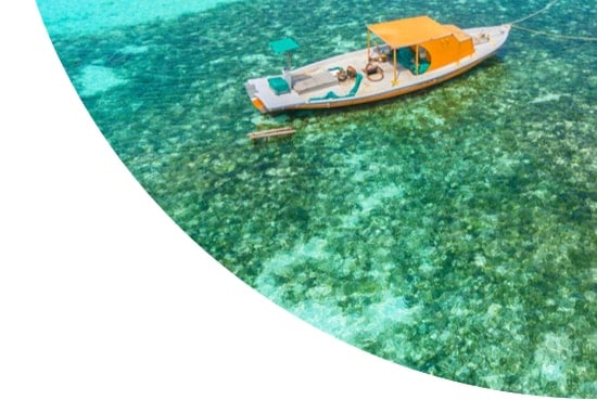 Boat in the water near Olhuveli island in the Maldives